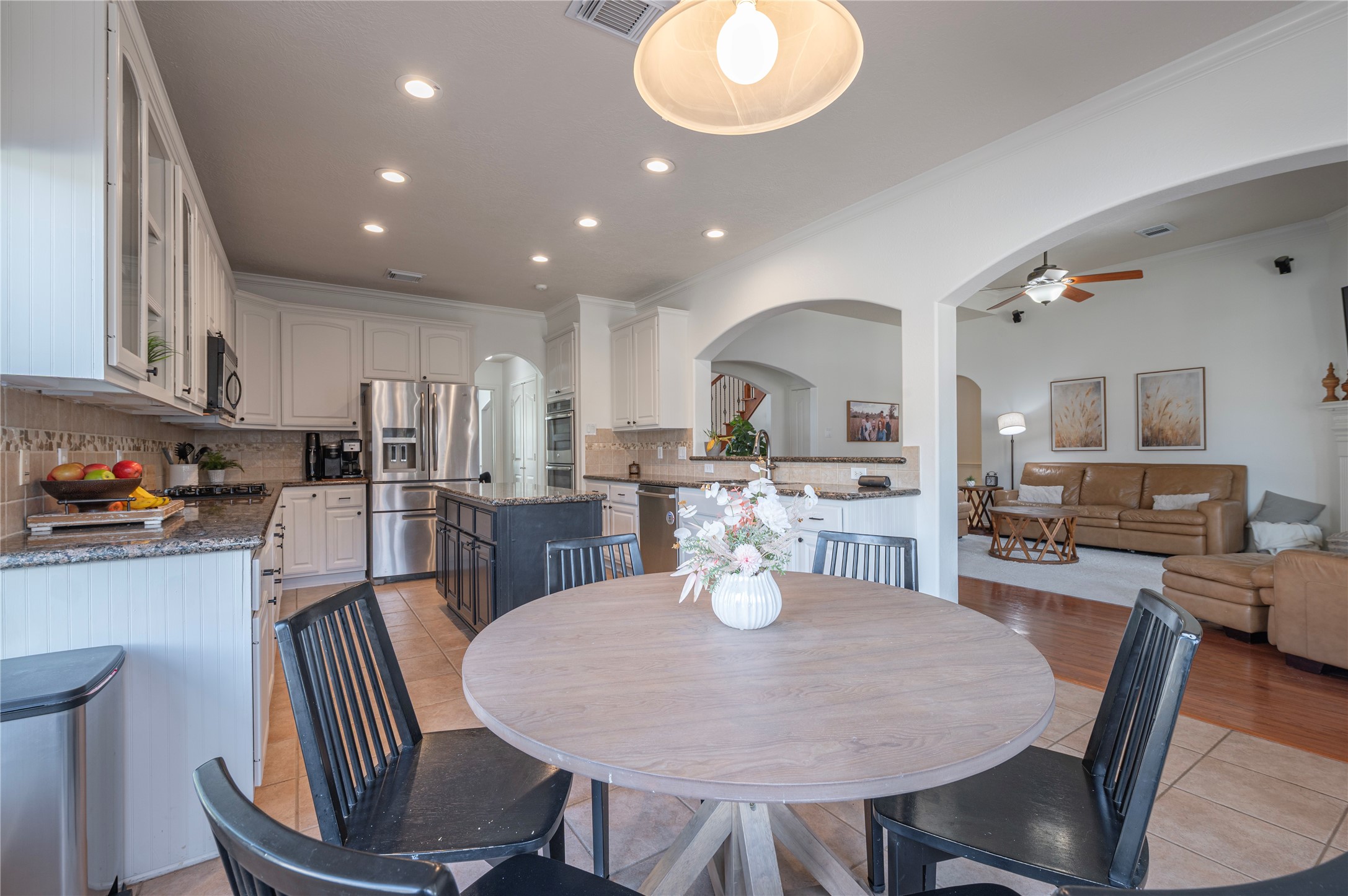 700 Red Oak Lane Friendswood, TX 77546 - Photo 16 of 48 an open kitchen with dining table and chairs