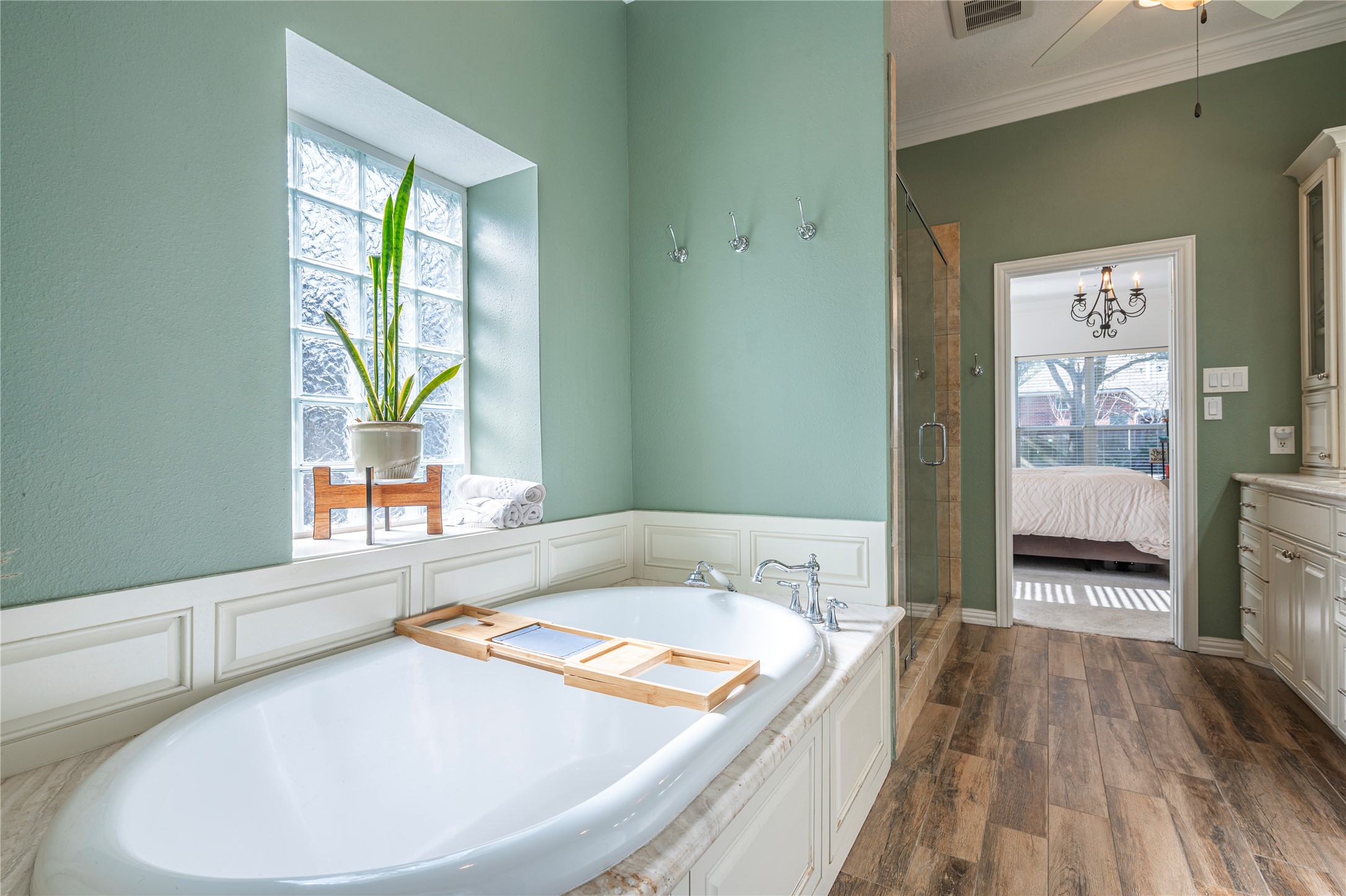 700 Red Oak Lane Friendswood, TX 77546 - Photo 25 of 48 a bathroom with a granite countertop sink a bathtub and next to a window