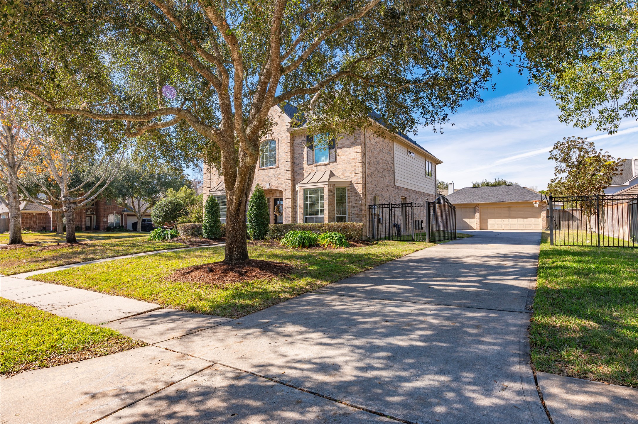 700 Red Oak Lane Friendswood, TX 77546 - Photo 3 of 48 a house with trees in front of it