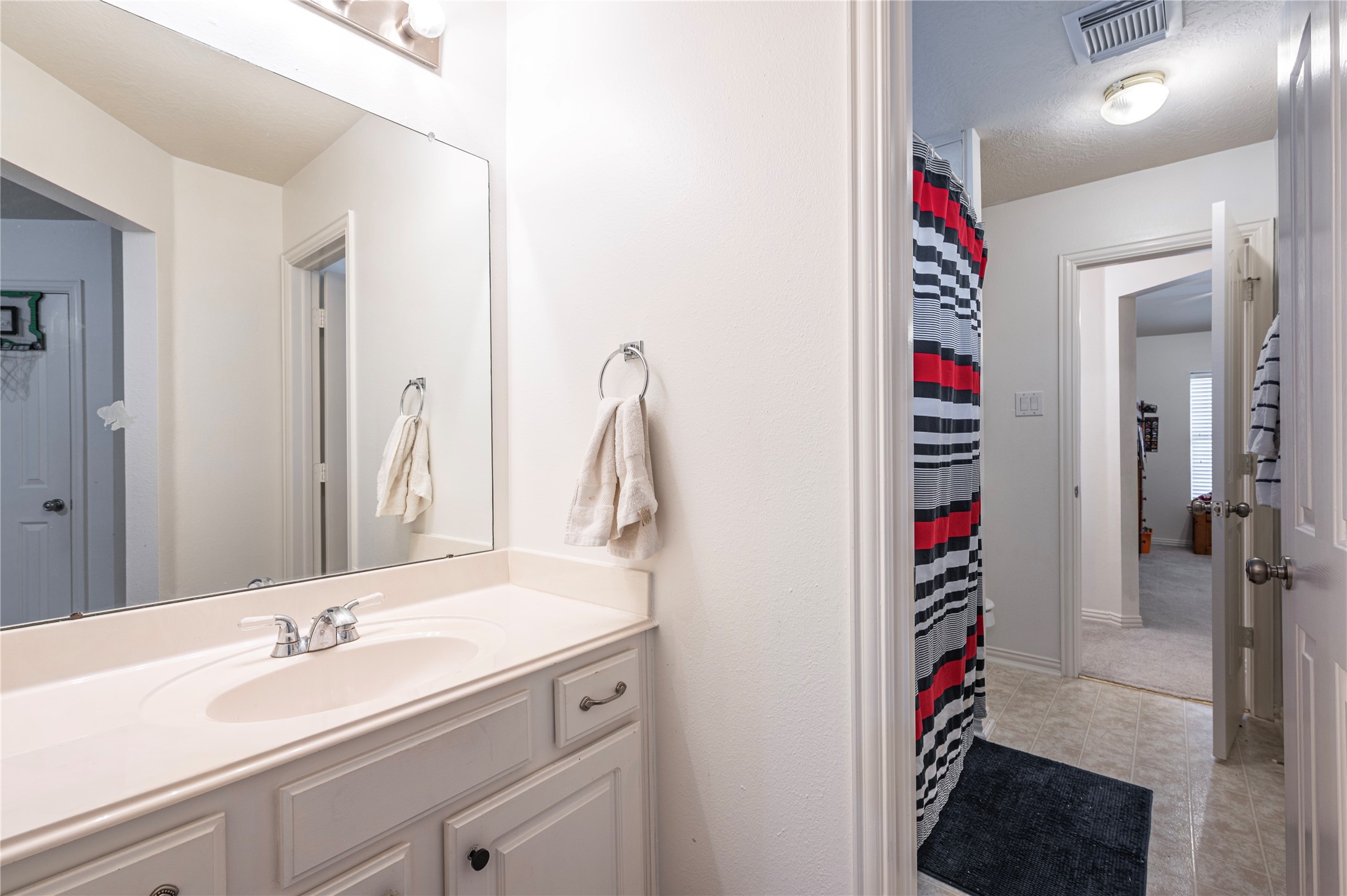 700 Red Oak Lane Friendswood, TX 77546 - Photo 31 of 48 a bathroom with a sink and a mirror