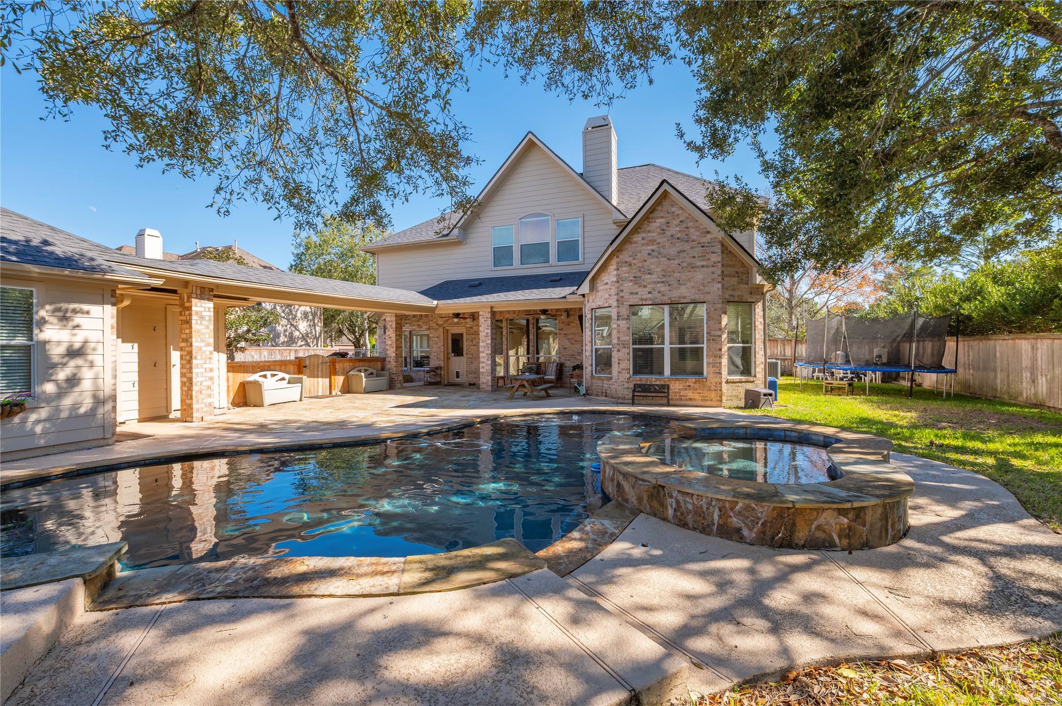 700 Red Oak Lane Friendswood, TX 77546 - Photo 42 of 48 a view of a house with swimming pool and sitting area
