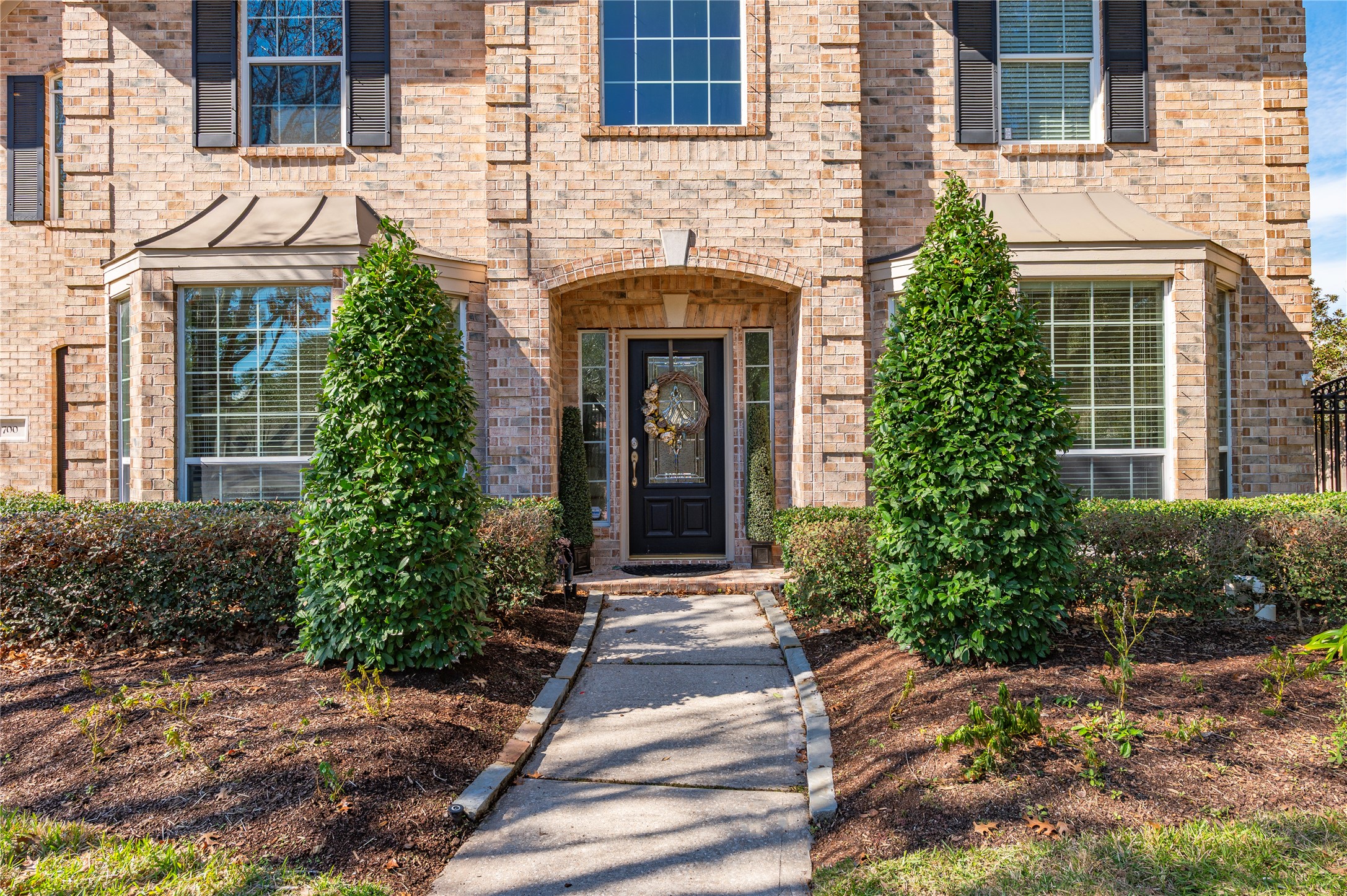 700 Red Oak Lane Friendswood, TX 77546 - Photo 5 of 48 a front view of a house with garden