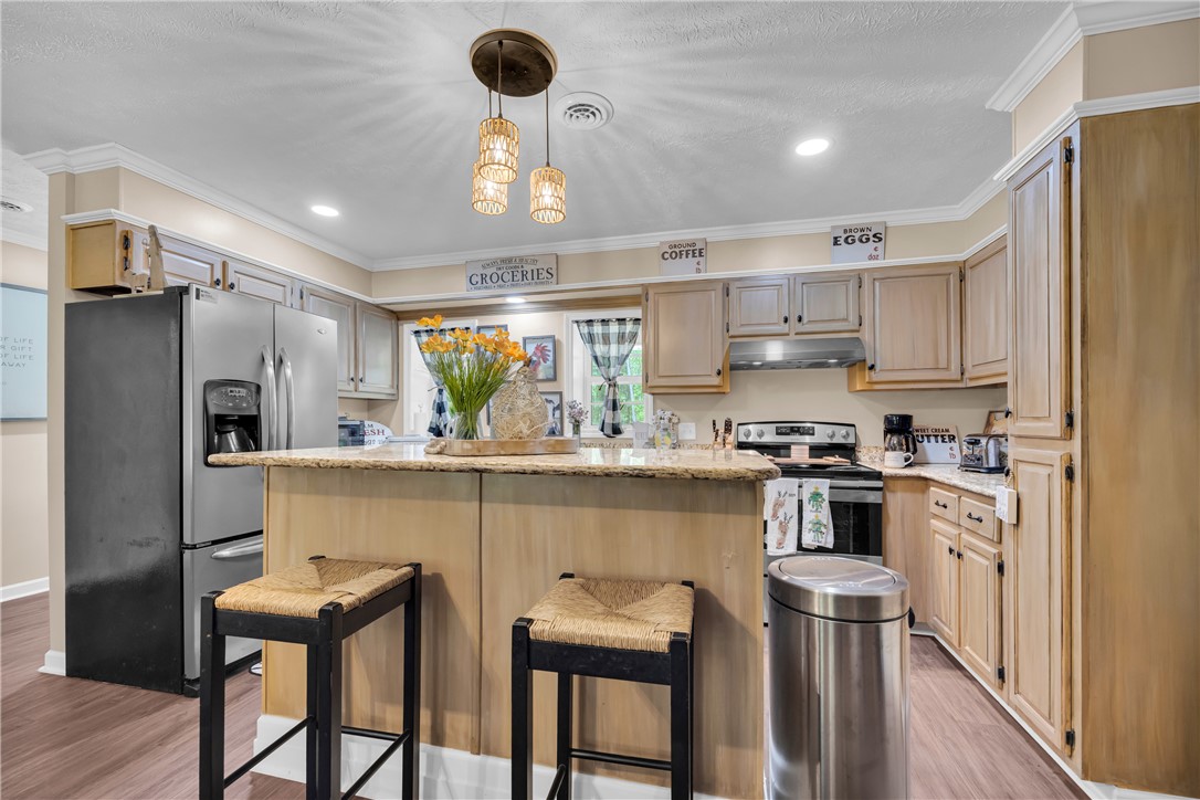 3030 Smith McGee Road Iva, SC 29655 - Photo 17 of 46 A well-appointed kitchen showcasing a practical island with seating and stainless steel appliances.