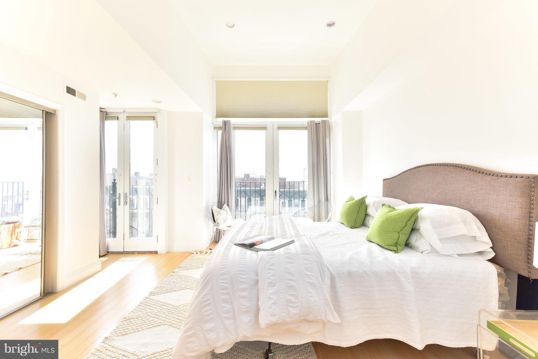 2713 Ontario Road Northwest, Unit 4 Washington, DC 20009 - Photo 13 of 25 a bedroom with a bed and a large window