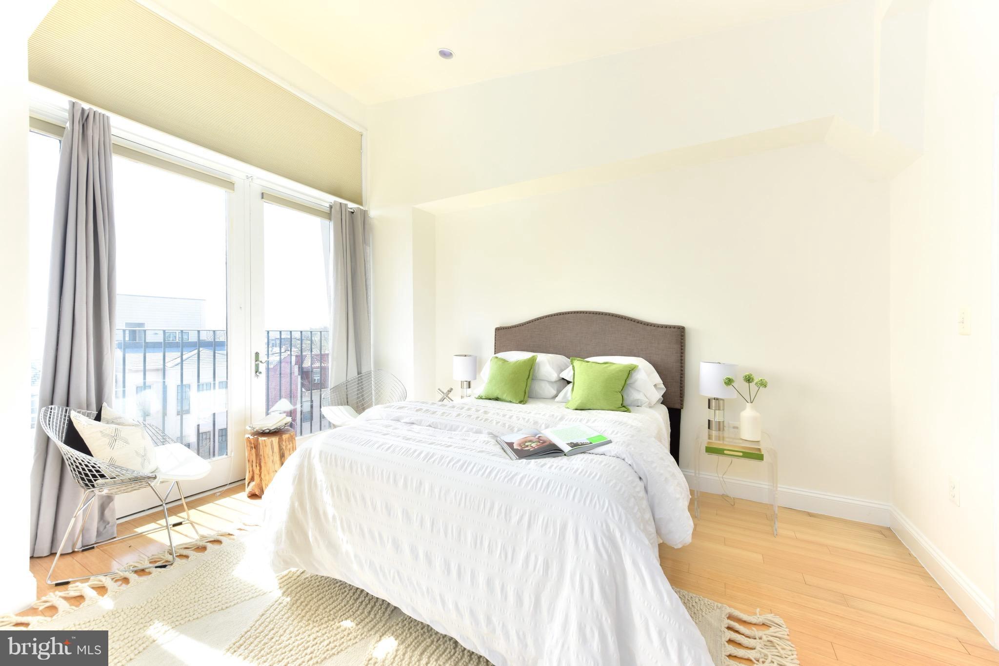 2713 Ontario Road Northwest, Unit 4 Washington, DC 20009 - Photo 14 of 25 a bedroom with a bed and a large window