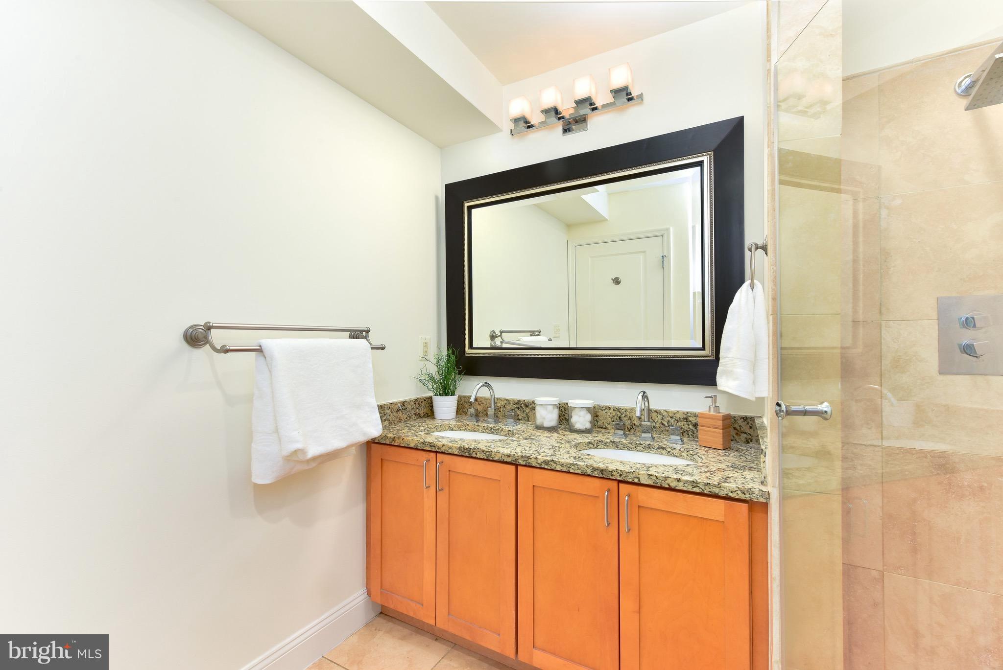 2713 Ontario Road Northwest, Unit 4 Washington, DC 20009 - Photo 19 of 25 a bathroom with a granite countertop sink and a mirror