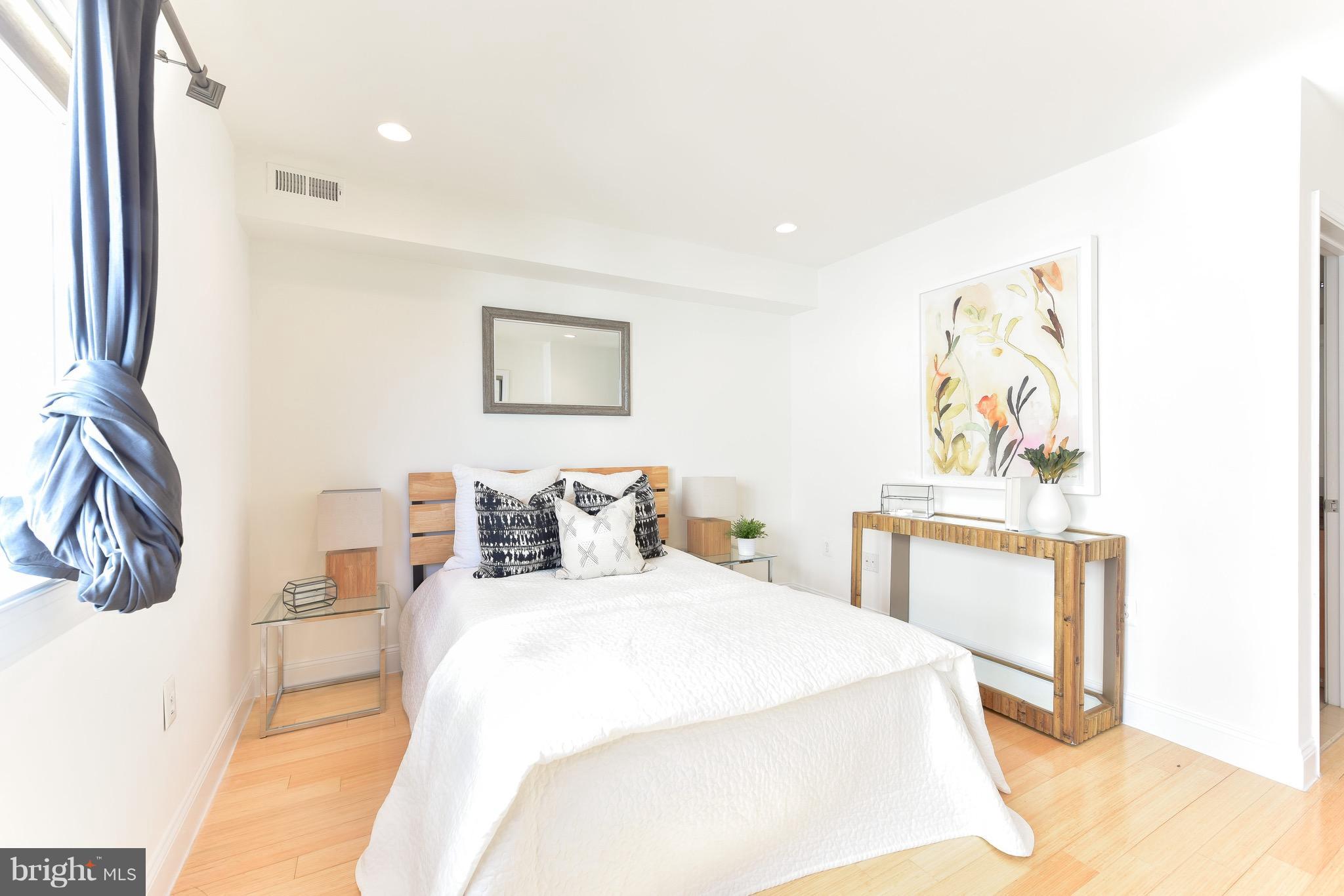 2713 Ontario Road Northwest, Unit 4 Washington, DC 20009 - Photo 21 of 25 a bedroom with a bed and a painting on the wall