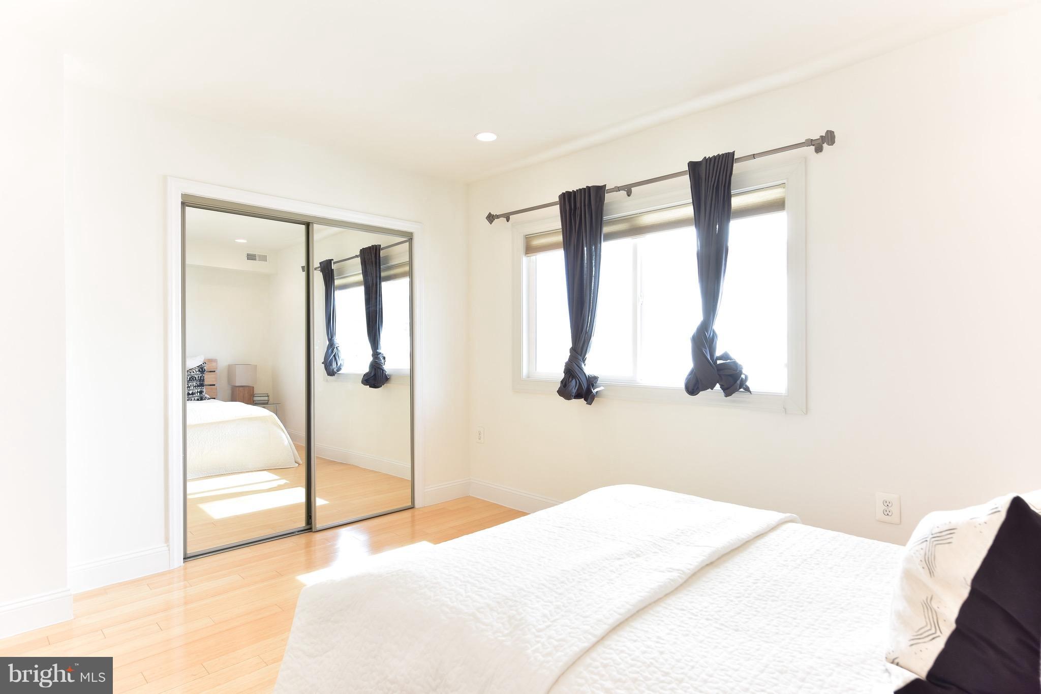 2713 Ontario Road Northwest, Unit 4 Washington, DC 20009 - Photo 22 of 25 a bedroom with a bed and a large mirror