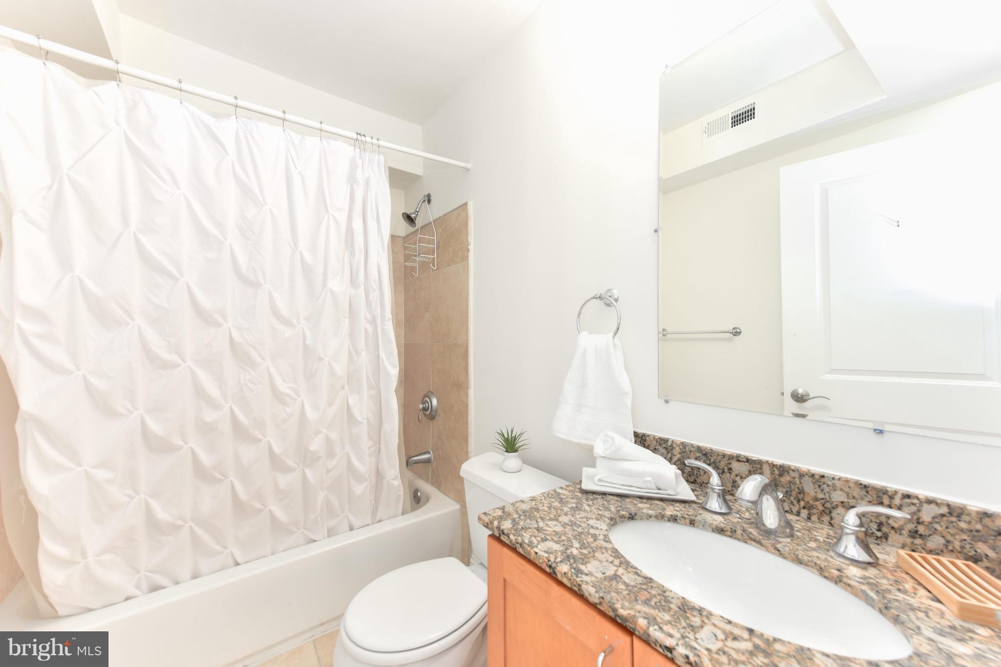 2713 Ontario Road Northwest, Unit 4 Washington, DC 20009 - Photo 23 of 25 a bathroom with a granite countertop sink and a mirror