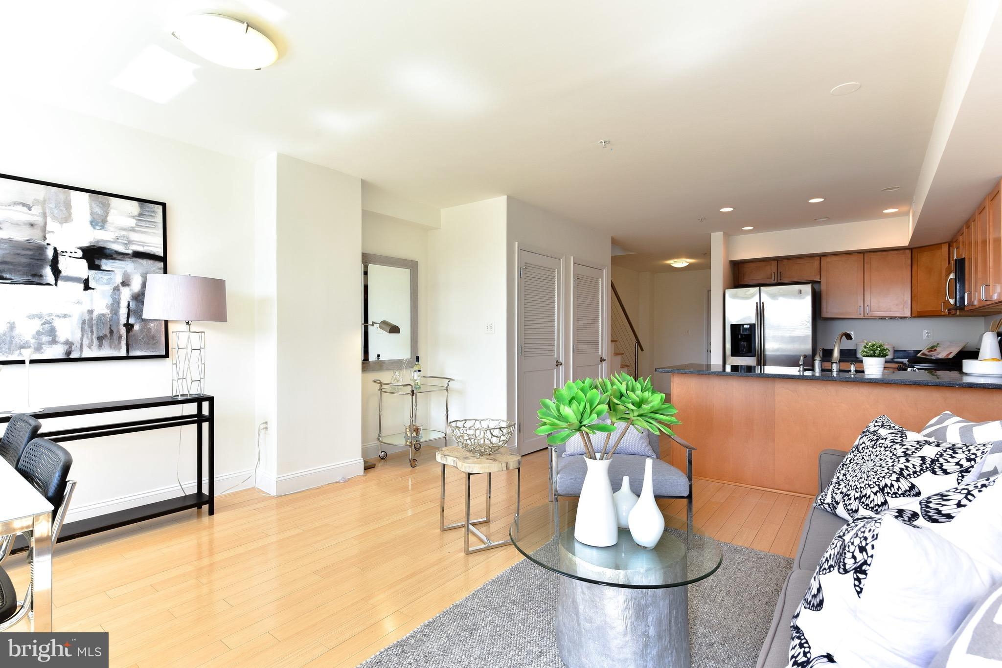 2713 Ontario Road Northwest, Unit 4 Washington, DC 20009 - Photo 6 of 25 a living room with furniture and a dining table with potted plant