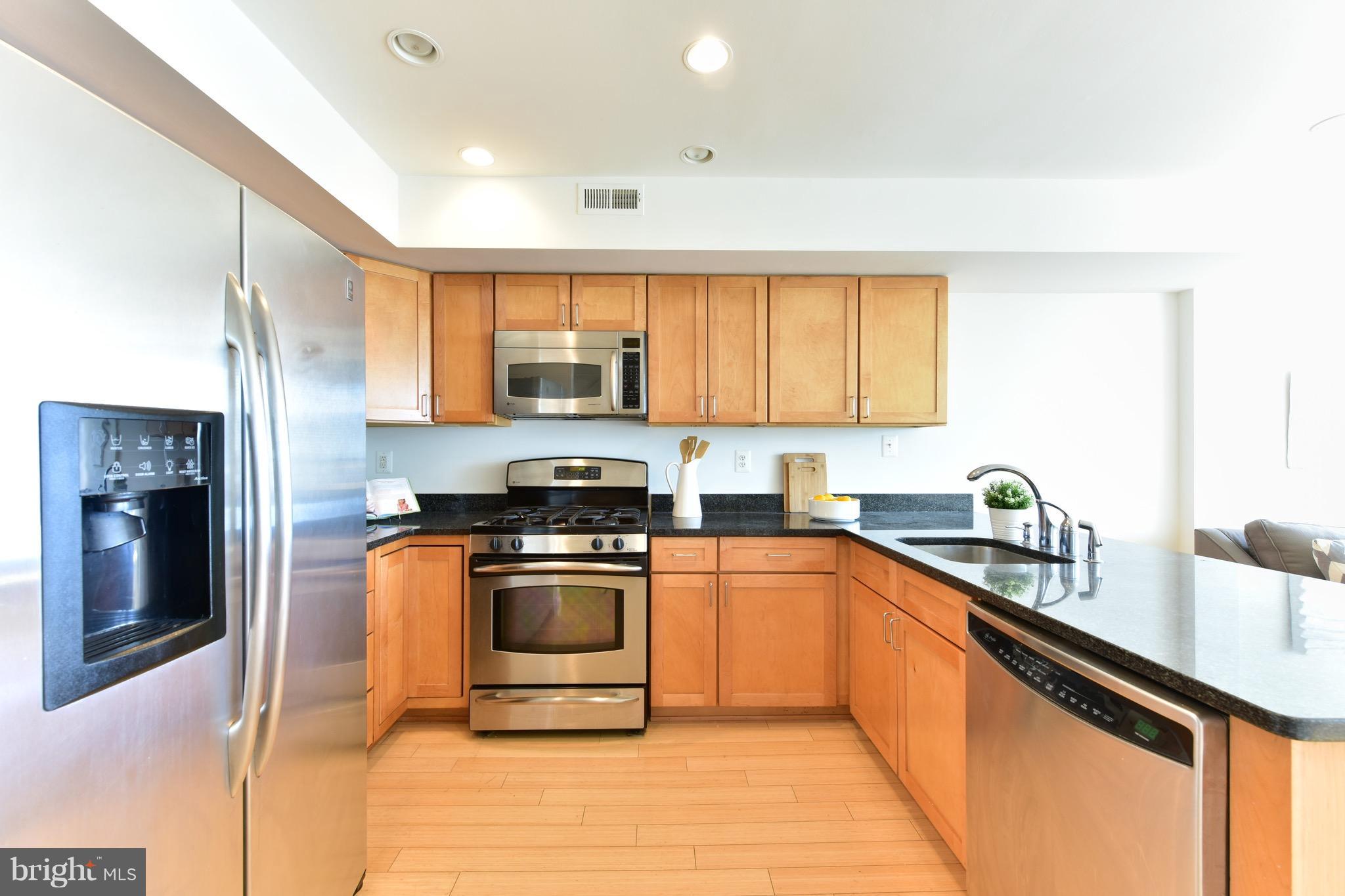 2713 Ontario Road Northwest, Unit 4 Washington, DC 20009 - Photo 10 of 25 a kitchen with stainless steel appliances granite countertop a sink stove and refrigerator