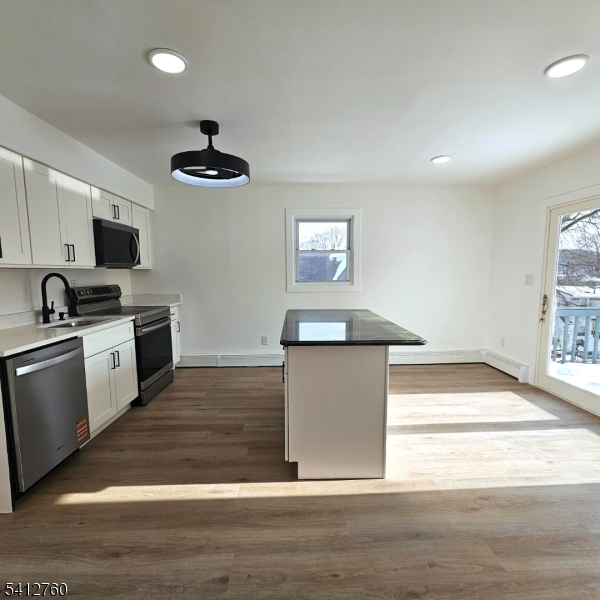 8 Berry Street, Unit 2 Dover, NJ 07801 - Photo 13 of 19 a kitchen with stainless steel appliances granite countertop a stove a sink and a microwave