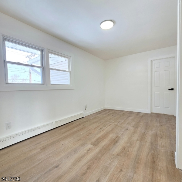 8 Berry Street, Unit 2 Dover, NJ 07801 - Photo 9 of 19 wooden floor in an empty room with a window