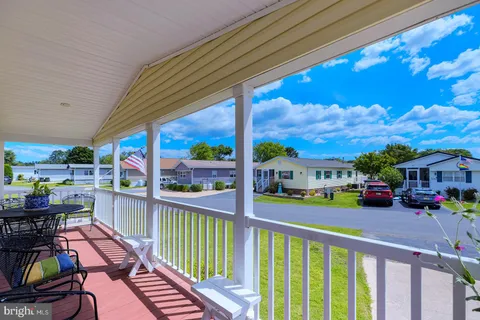 a view of a porch with furniture and garden
