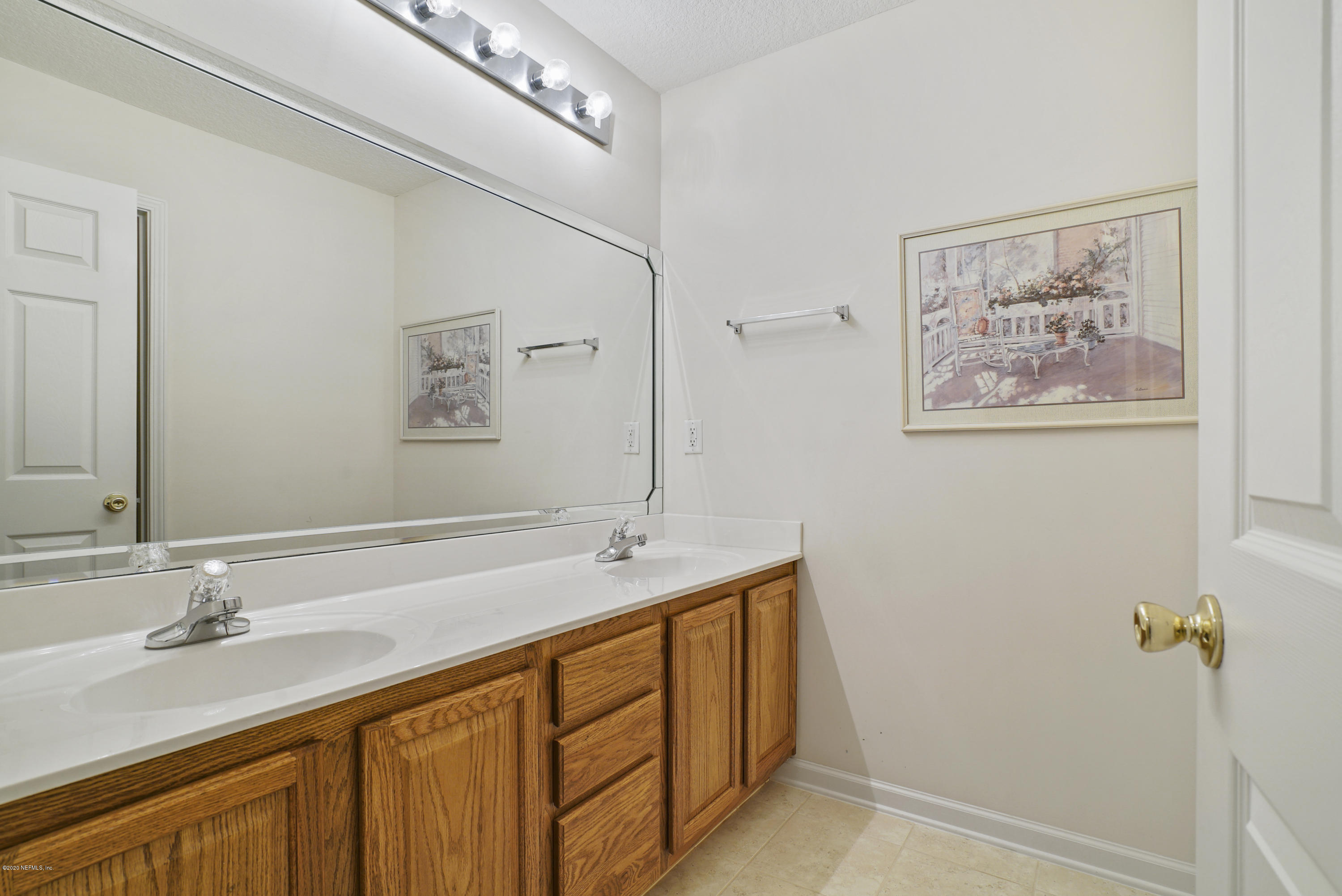 3158 Ravines Road Middleburg, FL 32068 - Photo 23 of 34 a bathroom with a double vanity sink and a mirror