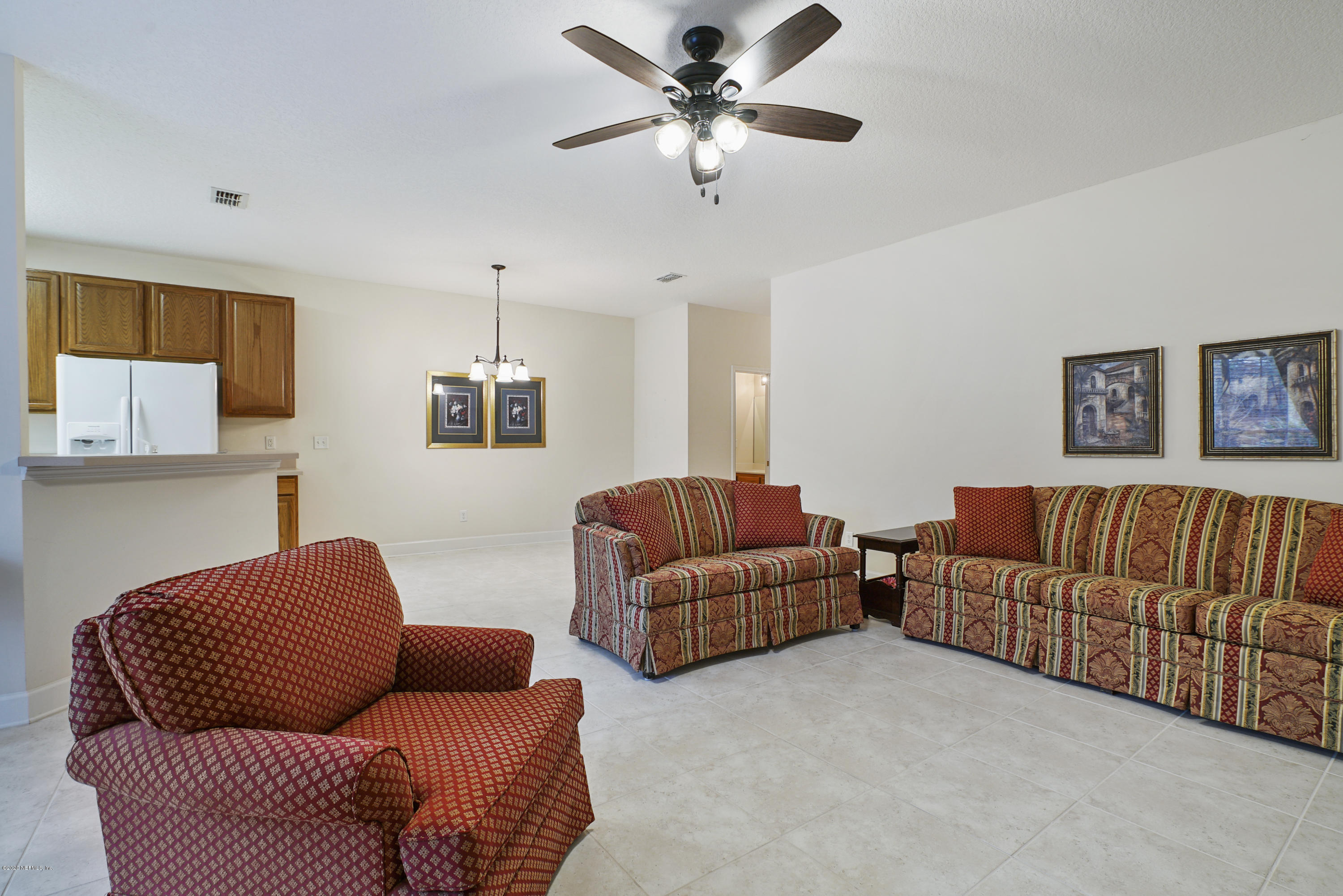 3158 Ravines Road Middleburg, FL 32068 - Photo 5 of 34 a living room with furniture ceiling fan and a window