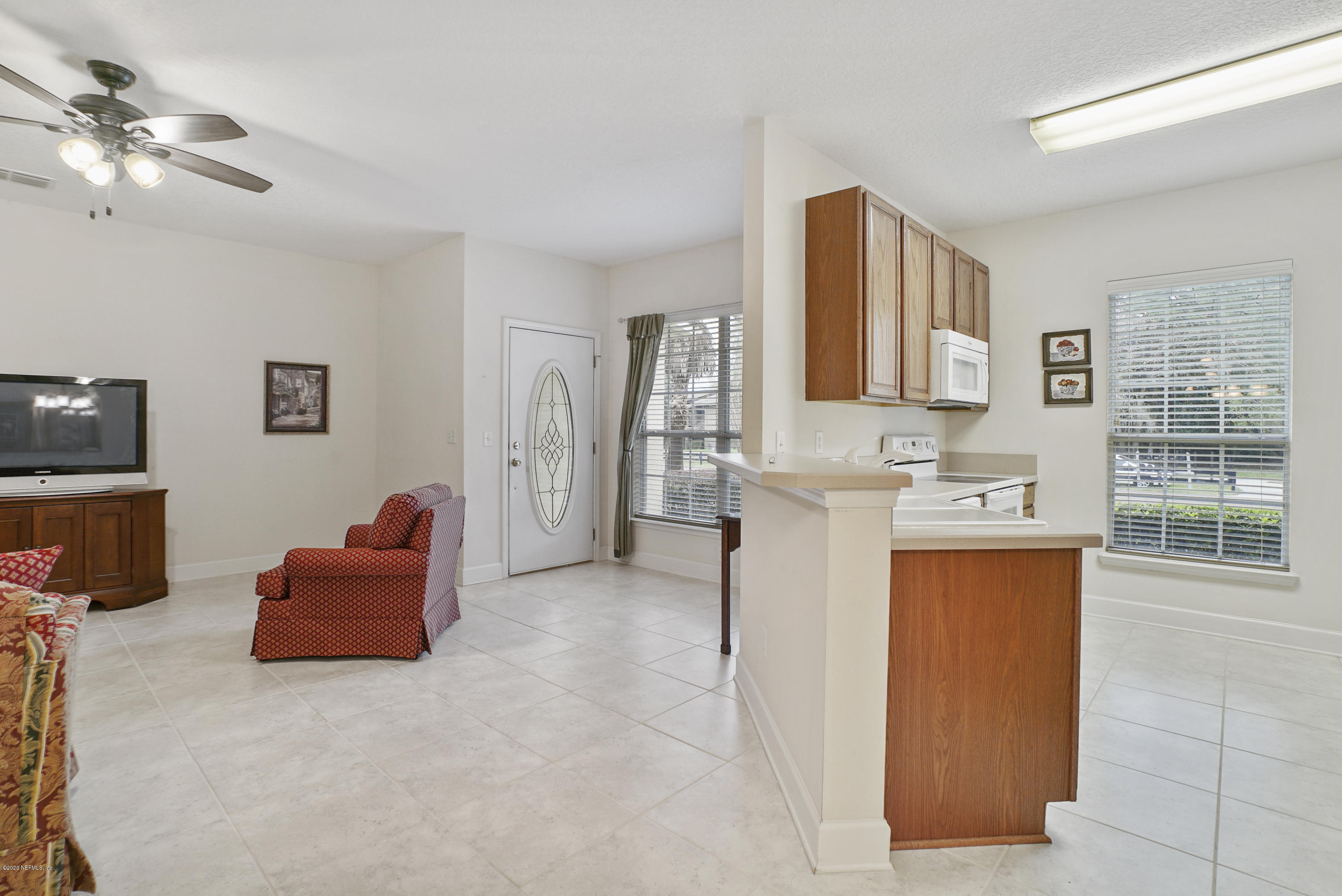 3158 Ravines Road Middleburg, FL 32068 - Photo 6 of 34 a living room with furniture a flat screen tv and a window