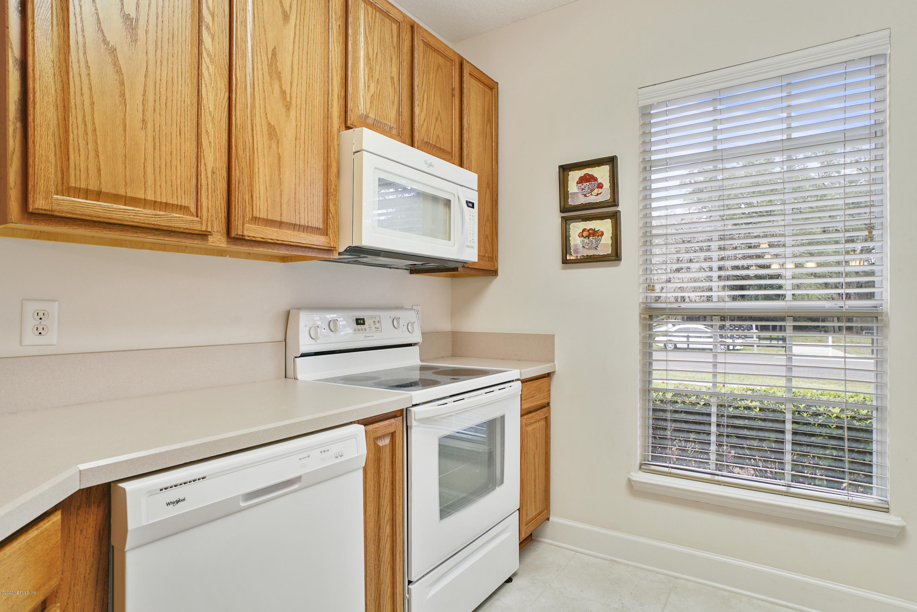 3158 Ravines Road Middleburg, FL 32068 - Photo 8 of 34 a kitchen with stainless steel appliances white cabinets and a window
