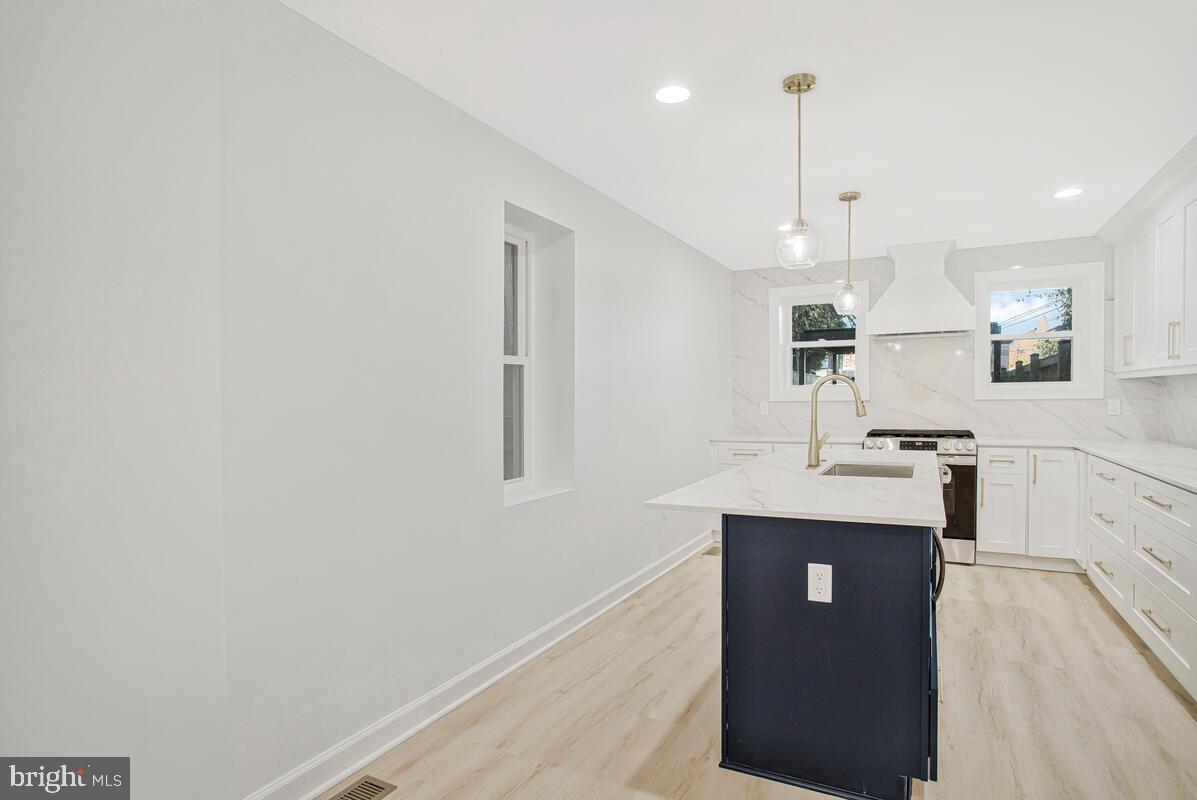 2258 Brookfield Avenue Baltimore, MD 21217 - Photo 12 of 42 a kitchen with kitchen island a counter top space a sink and appliances
