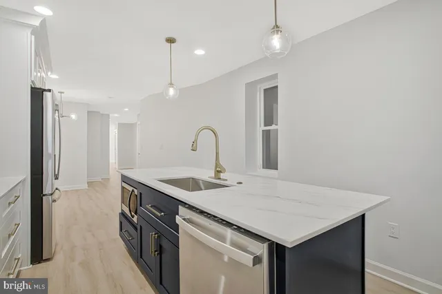 a kitchen with a sink and a refrigerator
