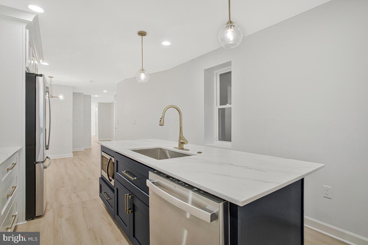 2258 Brookfield Avenue Baltimore, MD 21217 - Photo 14 of 42 a kitchen with a sink and a refrigerator