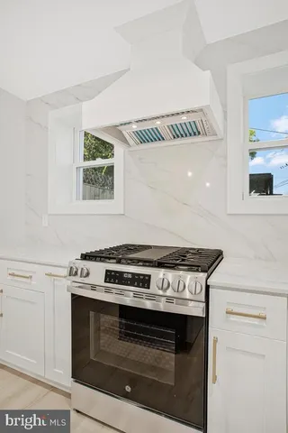 a stove top oven sitting inside of a kitchen