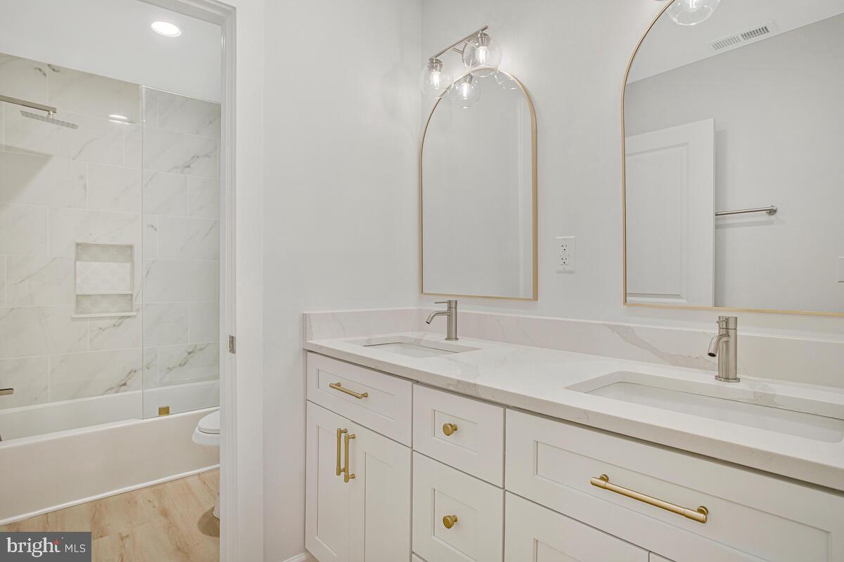 2258 Brookfield Avenue Baltimore, MD 21217 - Photo 17 of 42 a bathroom with a sink double vanity granite tub and shower