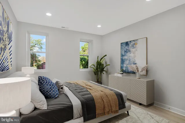 a bedroom with a bed and a painting on the wall