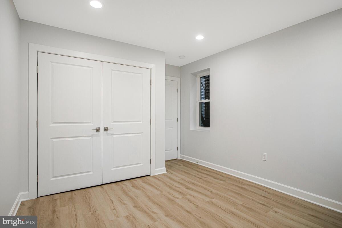 2258 Brookfield Avenue Baltimore, MD 21217 - Photo 21 of 42 a view of an empty room with wooden floor