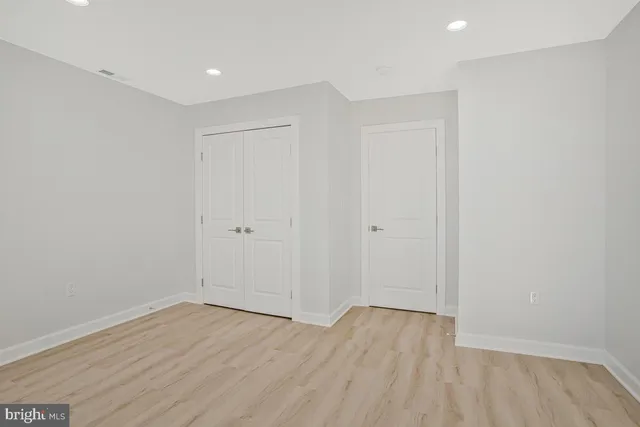 an empty room with wooden floor