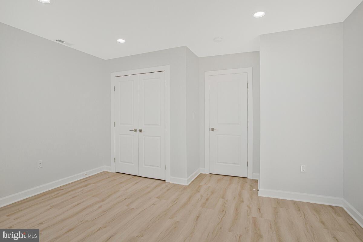 2258 Brookfield Avenue Baltimore, MD 21217 - Photo 25 of 42 an empty room with wooden floor