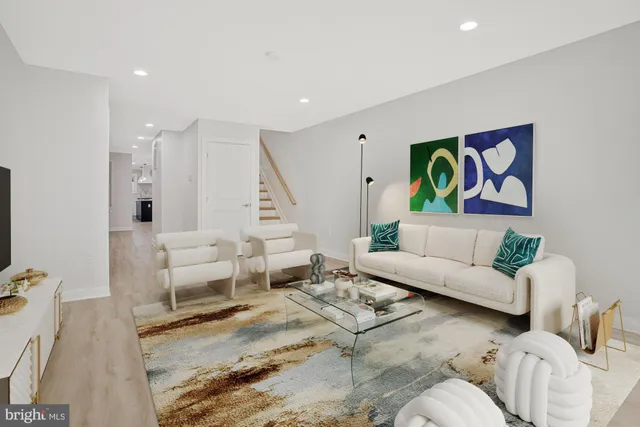 a living room with furniture and painting on the wall