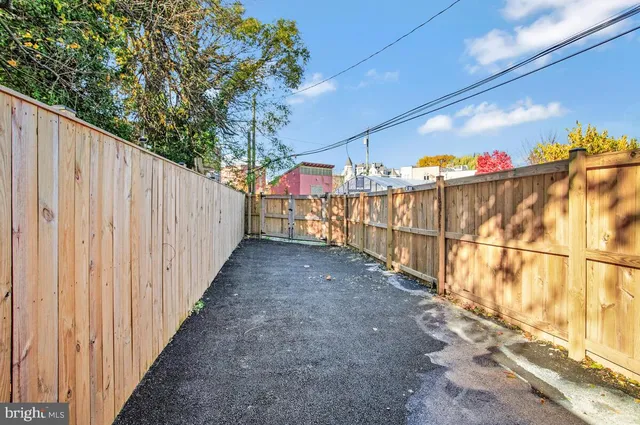 a view of a pathway with a wrought fence