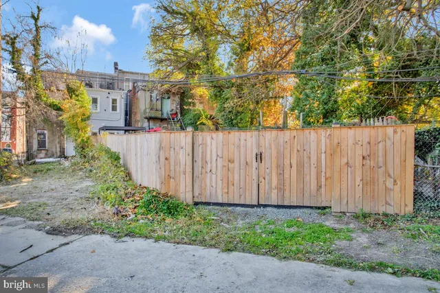 a view of a backyard with large trees