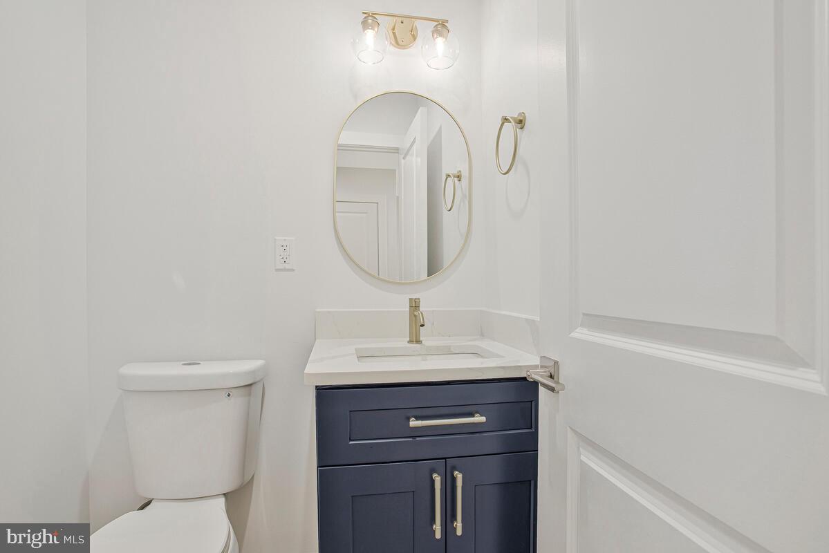 2258 Brookfield Avenue Baltimore, MD 21217 - Photo 6 of 42 a bathroom with a toilet sink and mirror