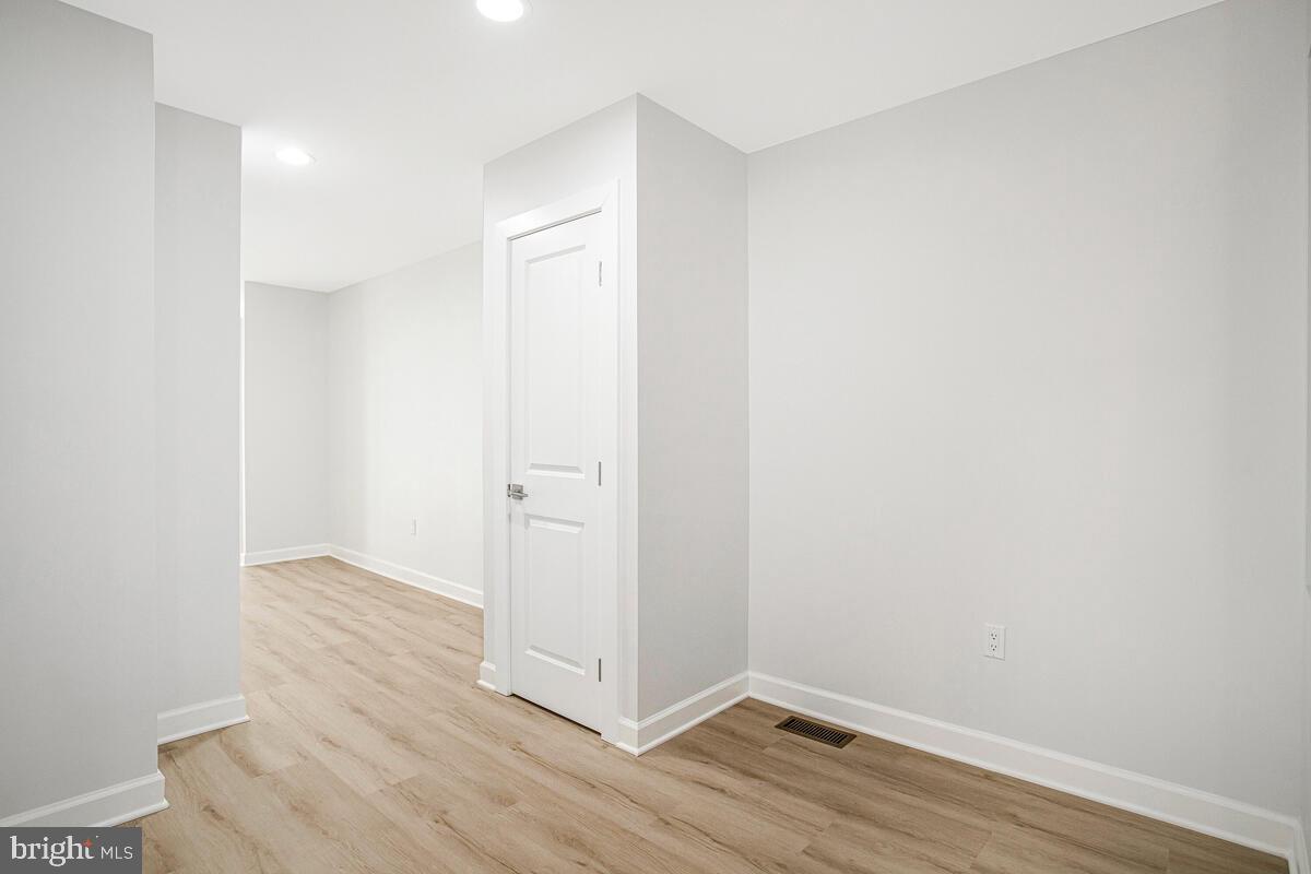 2258 Brookfield Avenue Baltimore, MD 21217 - Photo 8 of 42 a view of an empty room with wooden floor