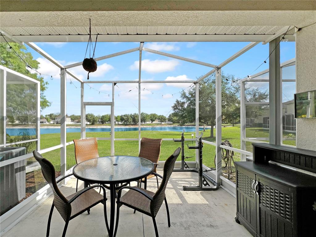 15767 Stable Run Drive Spring Hill, FL 34610 - Photo 14 of 34 a view of chairs and table in patio with a yard