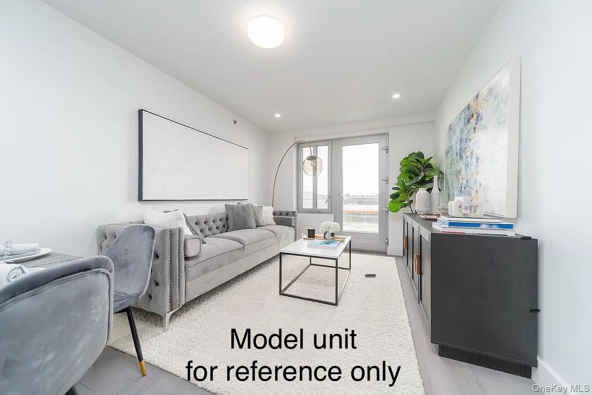 131-19 Fowler Avenue, Unit 4A Queens, NY 11355 - Photo 2 of 8 a living room with furniture and a large window