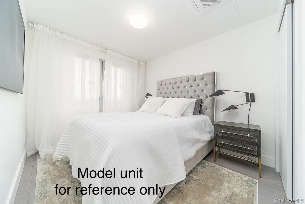 131-19 Fowler Avenue, Unit 4A Queens, NY 11355 - Photo 5 of 8 a bedroom with a bed and a table