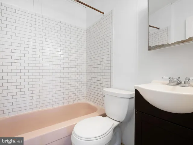 a bathroom with a sink a toilet and bathtub