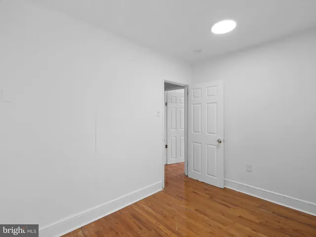 a view of an empty room and wooden floor