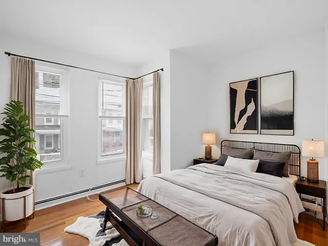 a bedroom with a bed and a potted plant