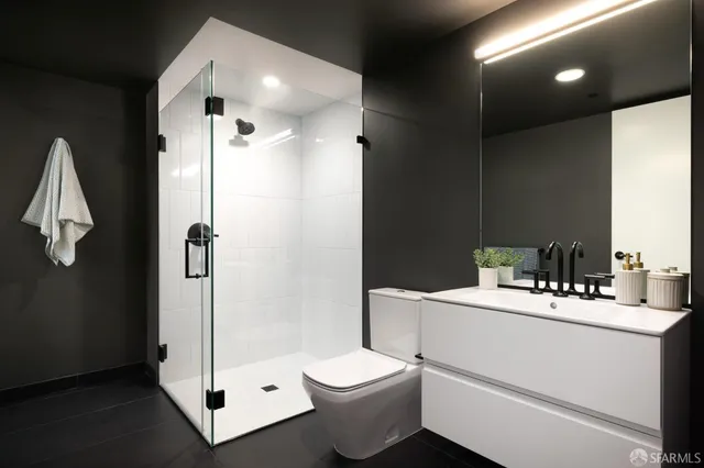 a bathroom with a sink toilet and shower