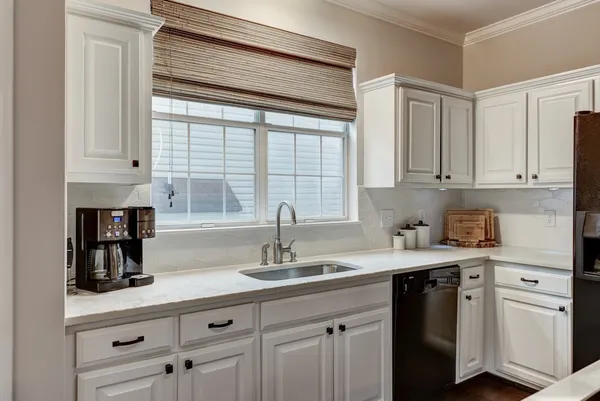 a kitchen with appliances cabinets and a window