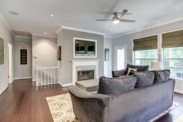 a living room with furniture a large window and a fireplace