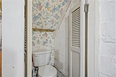 a white toilet sitting next to a shower curtain