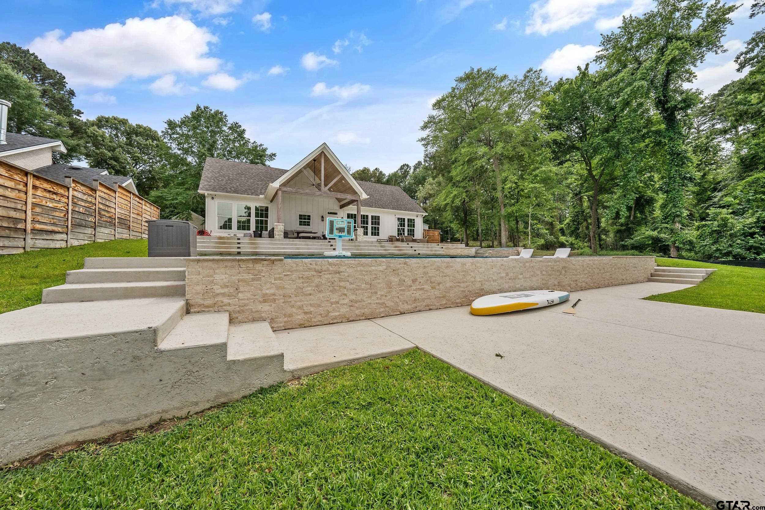 16837 Wilson Road Tyler, TX 75707 - Photo 39 of 44 a front view of a house with a yard and trees
