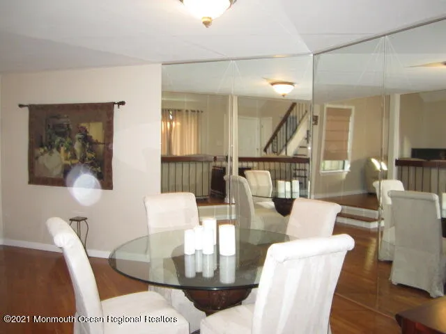 a living room with furniture a wooden floor and next to a window