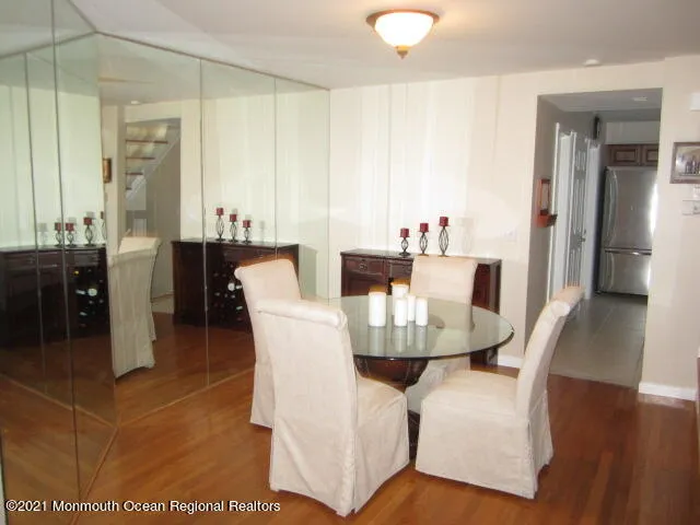 a dining room with furniture and wooden floor