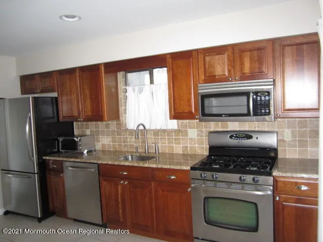 a kitchen with a stove microwave and refrigerator